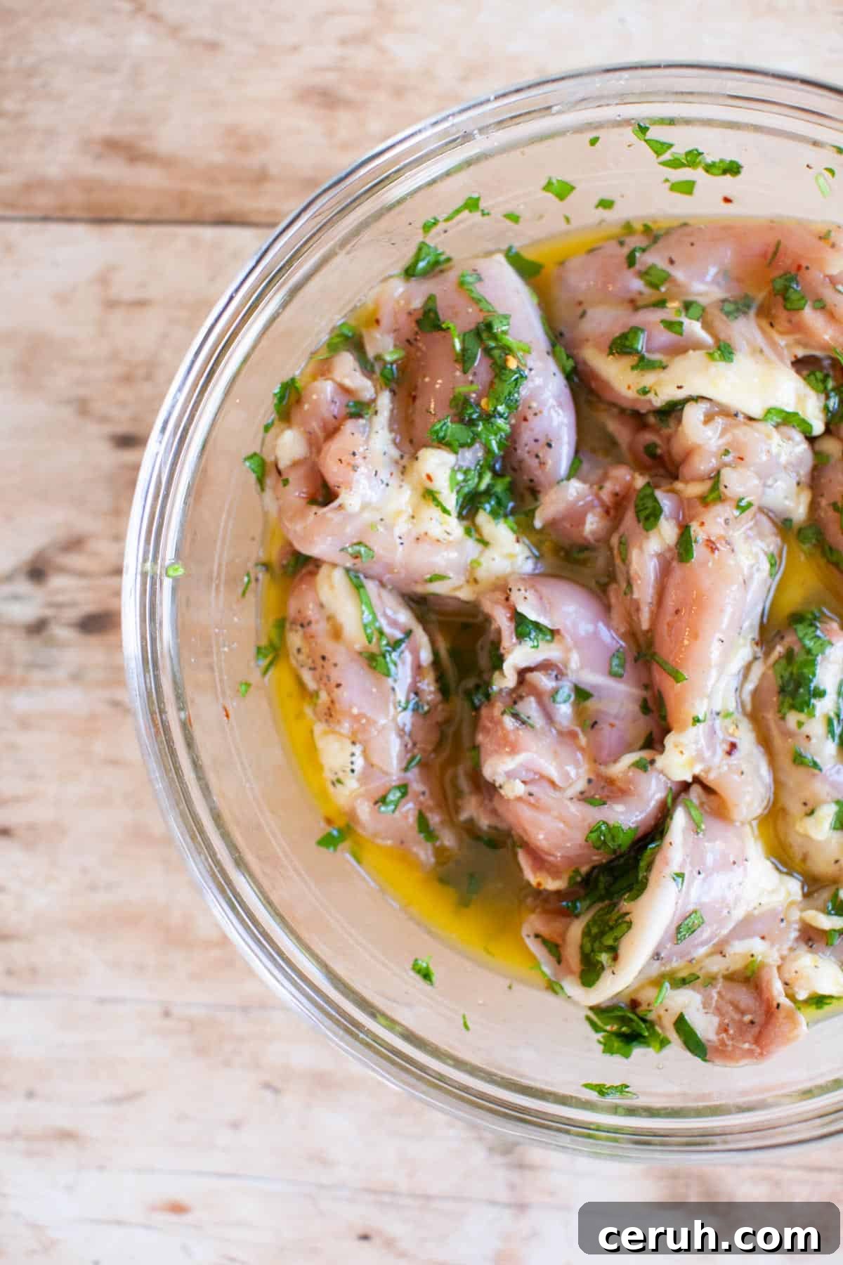 lemon chicken marinade poured over raw chicken.