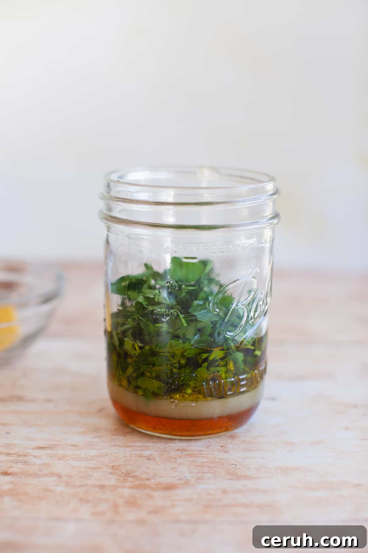 parsley leaves in a jar of marinade