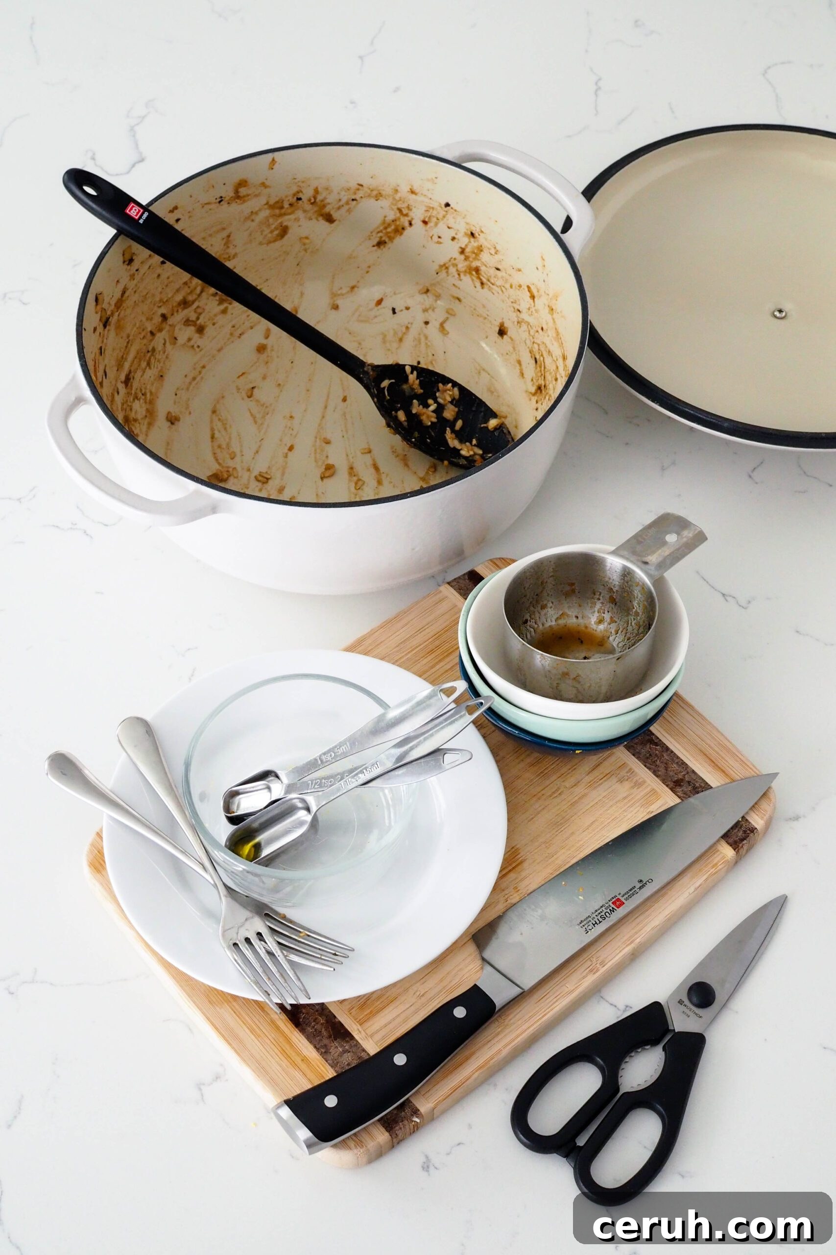 A collection of dishes used to make one-pot chicken and brown rice.