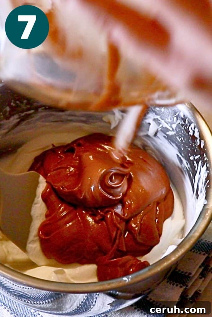 pouring the chocolate mixture into the remaining whipped cream