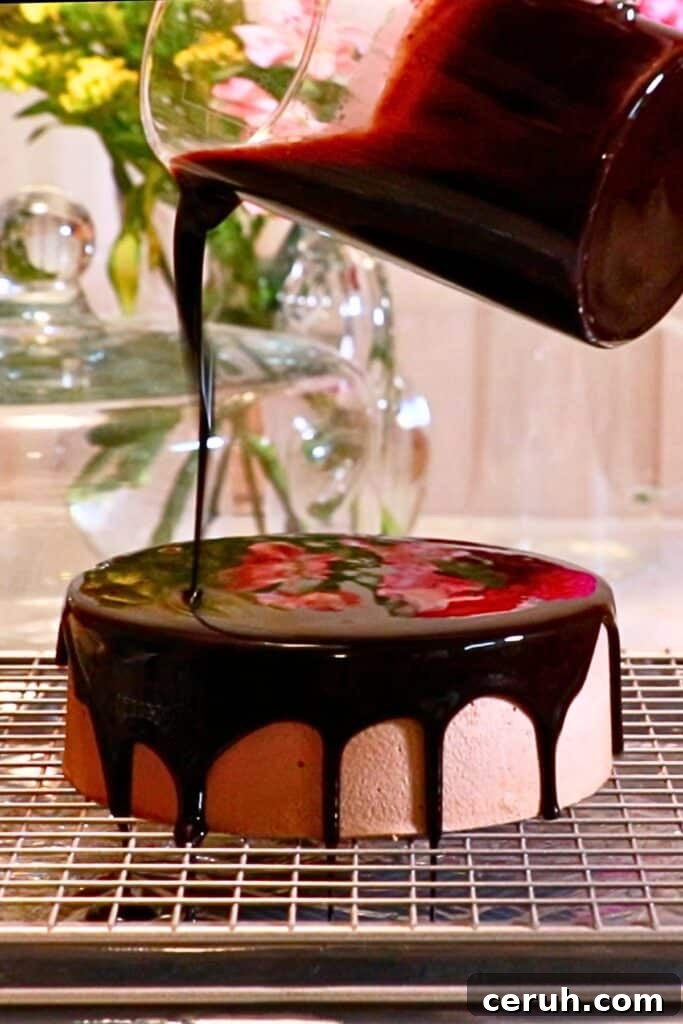pouring mirror glaze on a chocolate mousse cake
