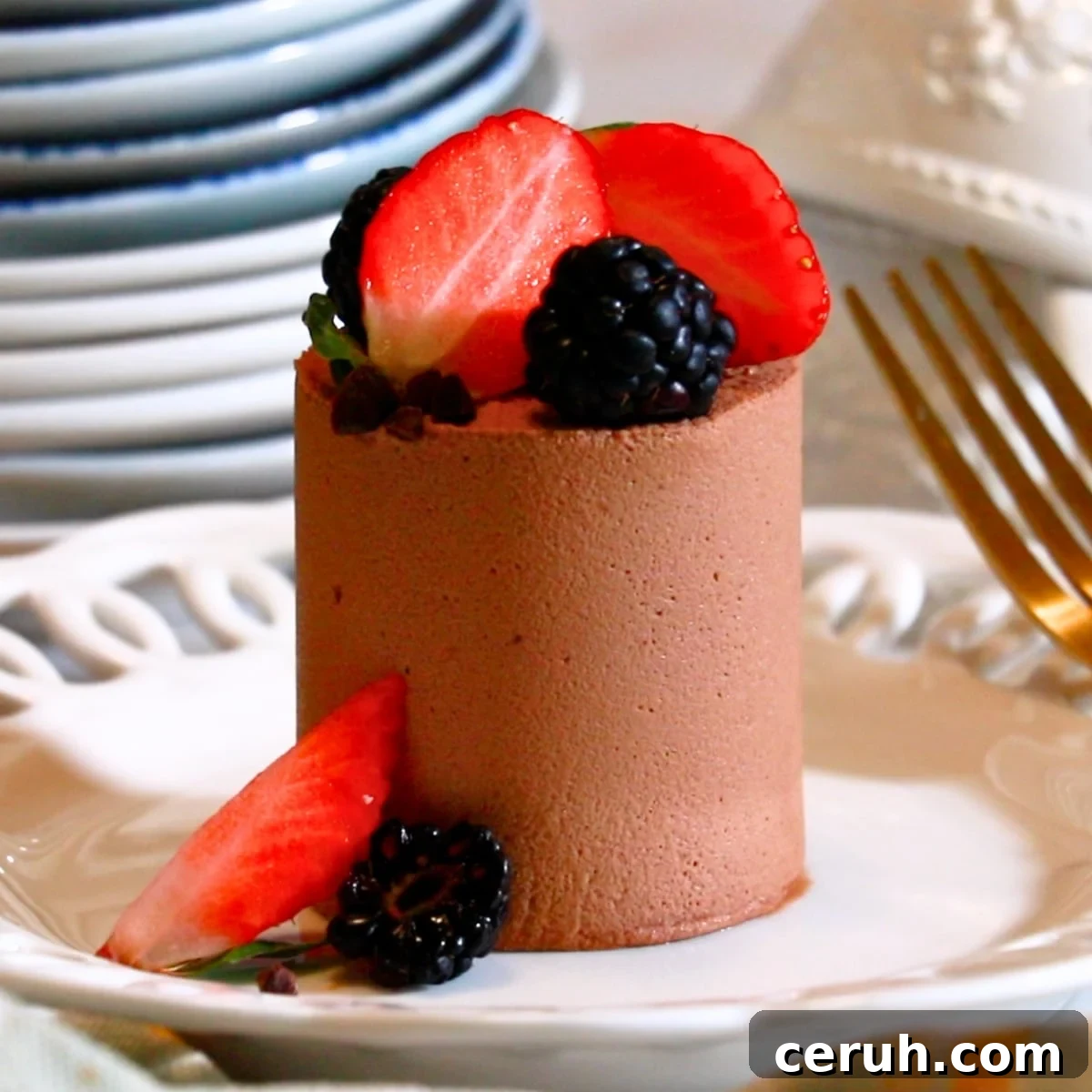 a mini chocolate mousse cake on a white plate