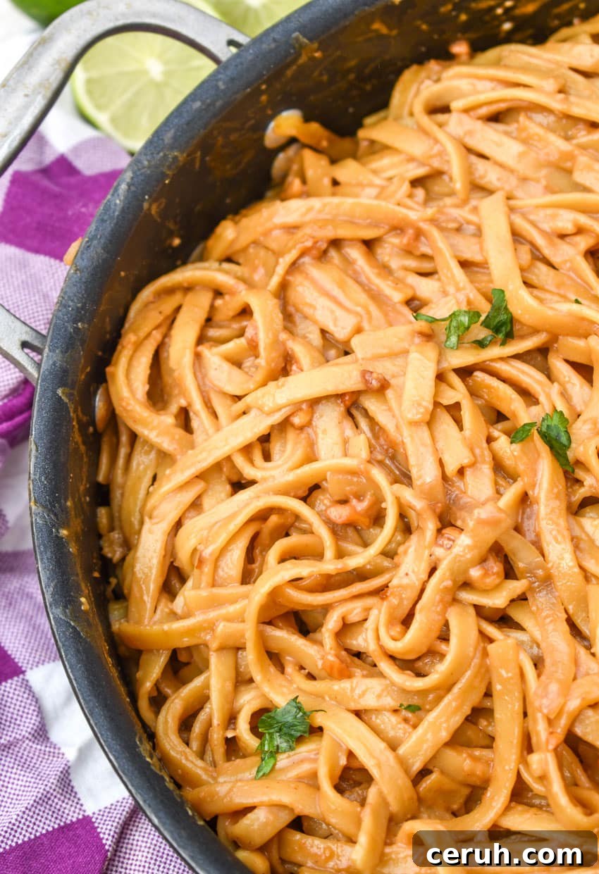 chinese peanut butter noodles in a large black skillet