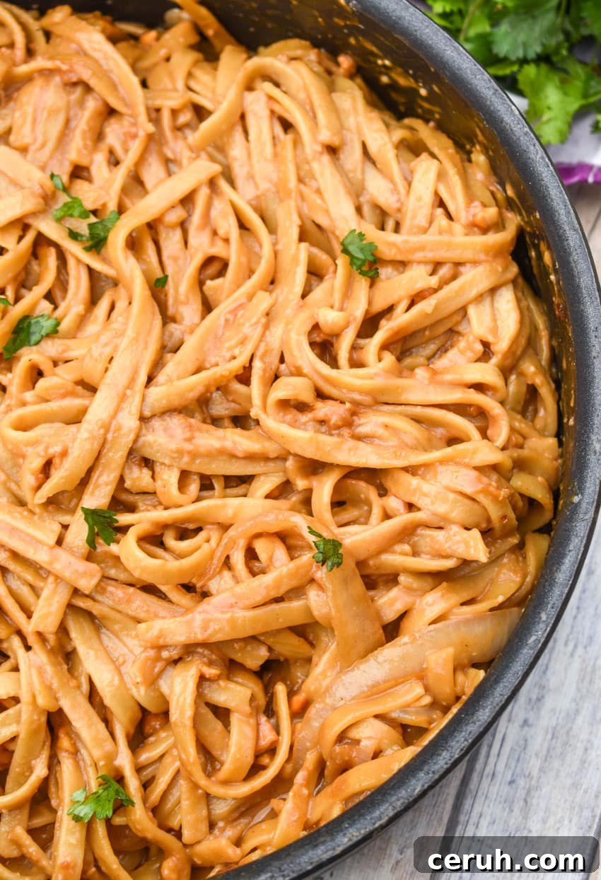 chinese peanut butter noodles in a large black skillet