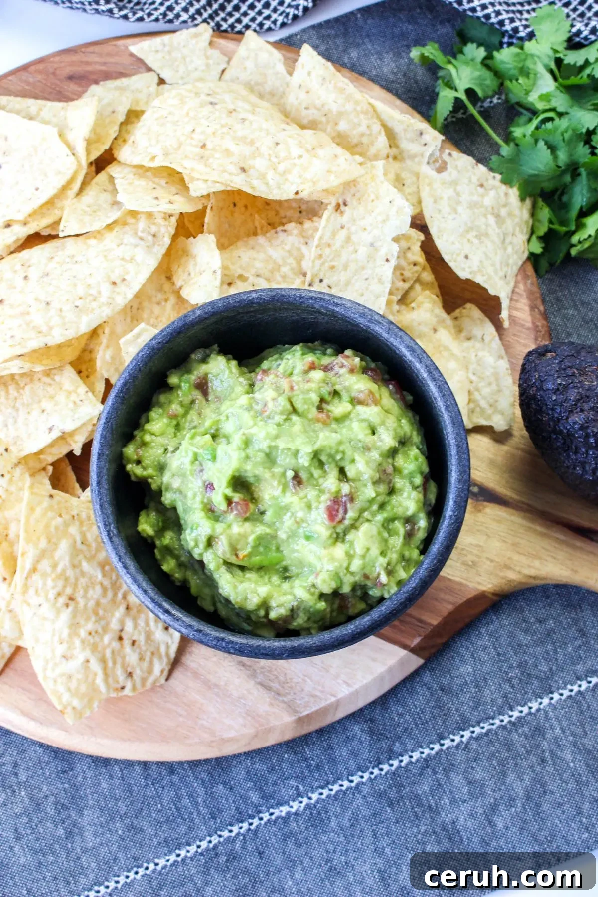 Looking down on a bowl of corn chips with guacamole.