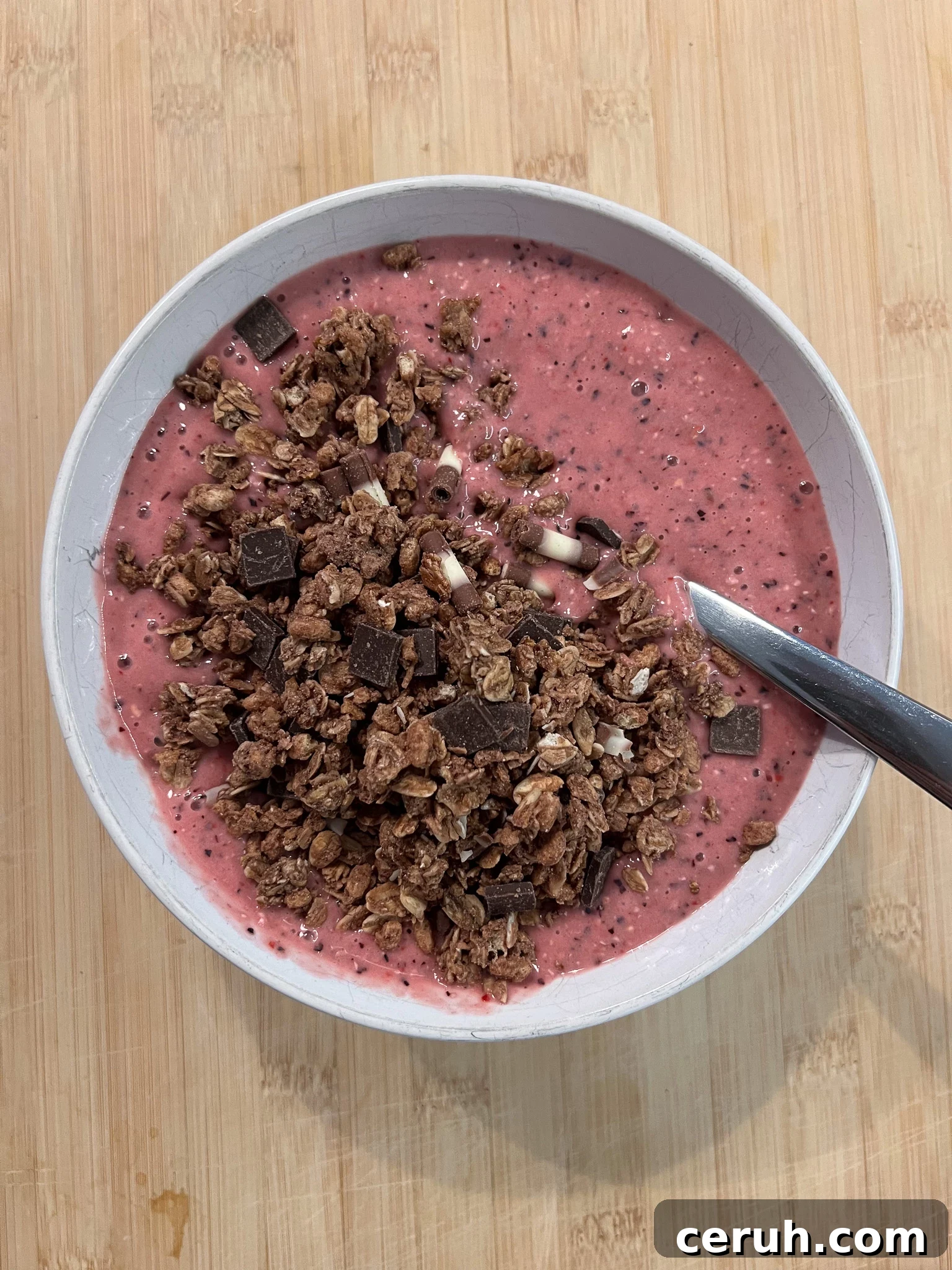 A smoothie bowl with chocolate granola.