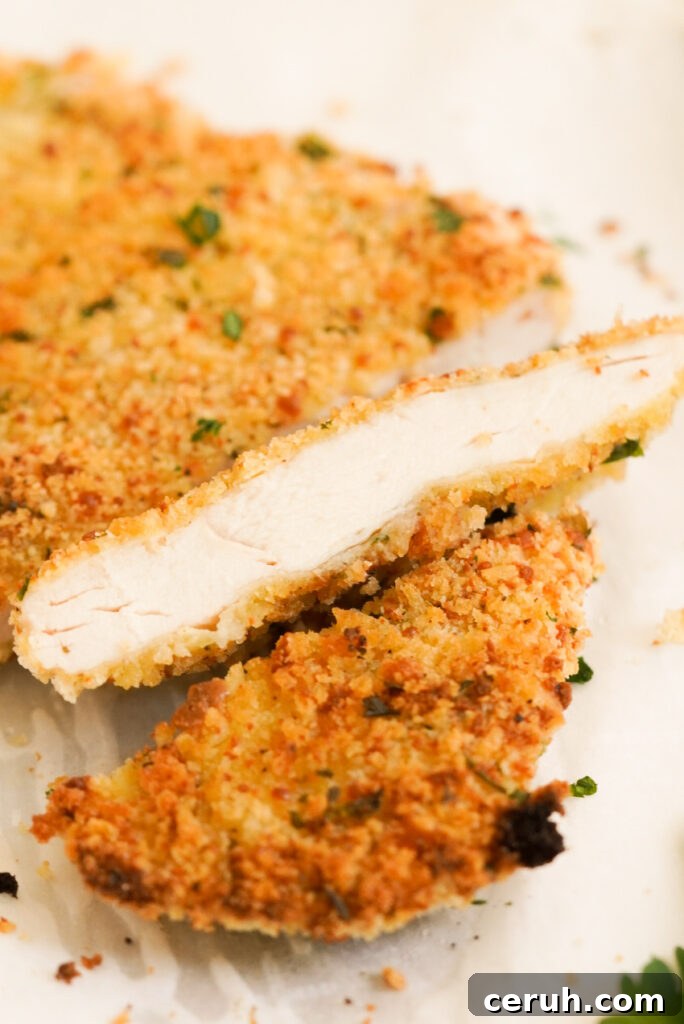 closeup shot of a slice of oven baked chicken cutlet.