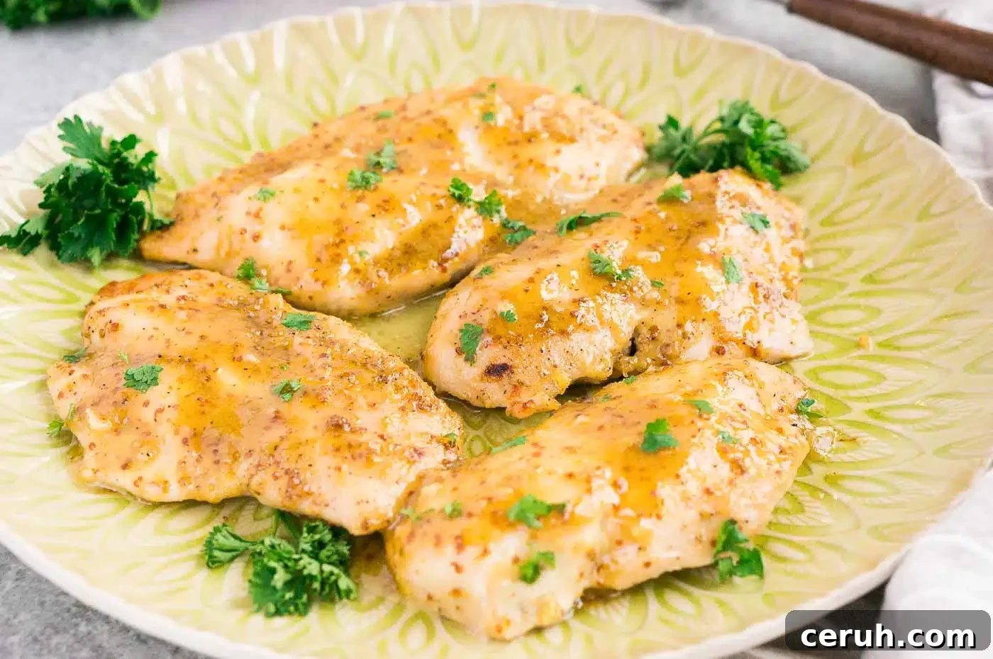 chicken in honey mustard sauce on a plate