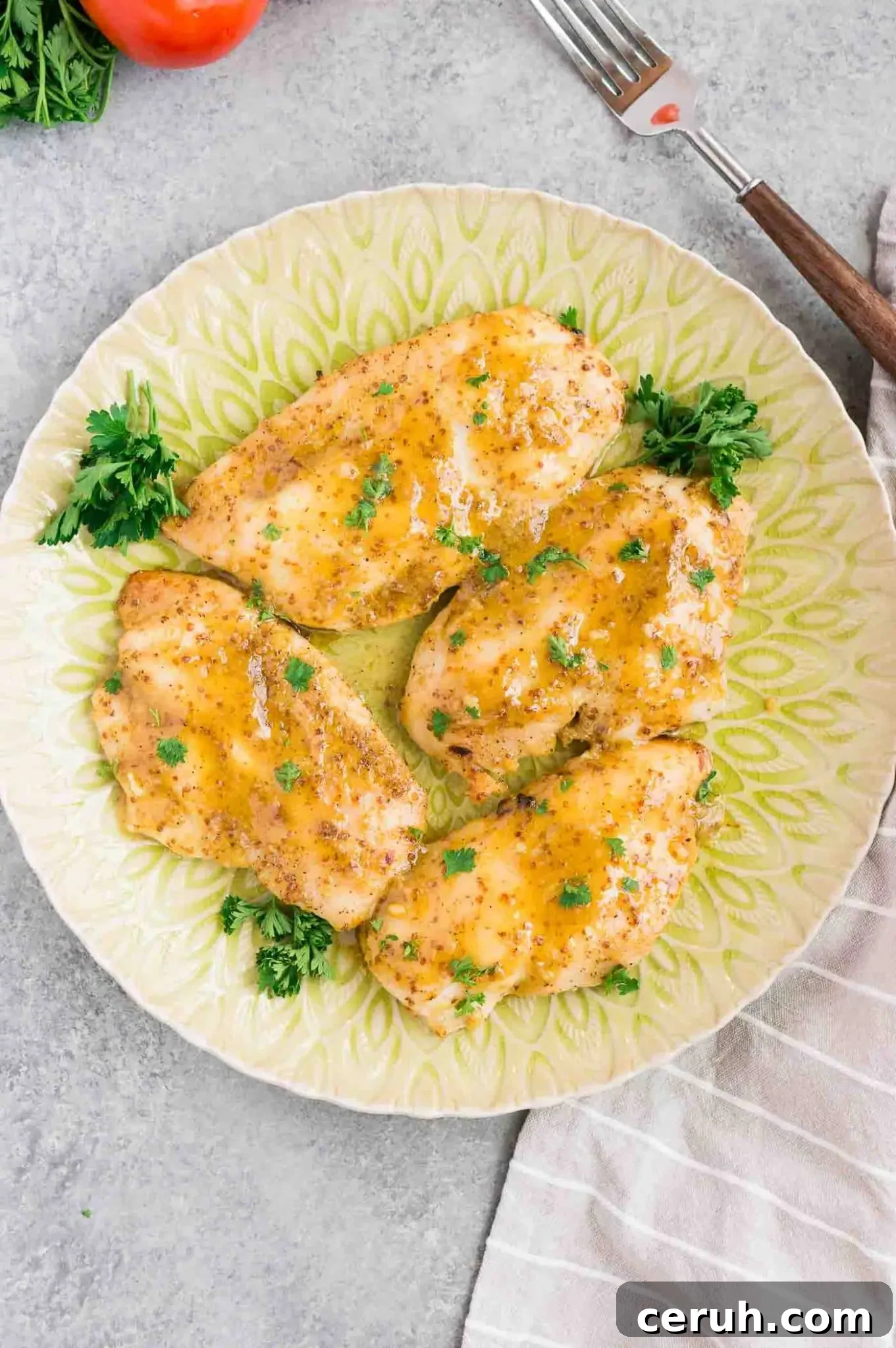 baked chicken in honey mustard sauce on a plate