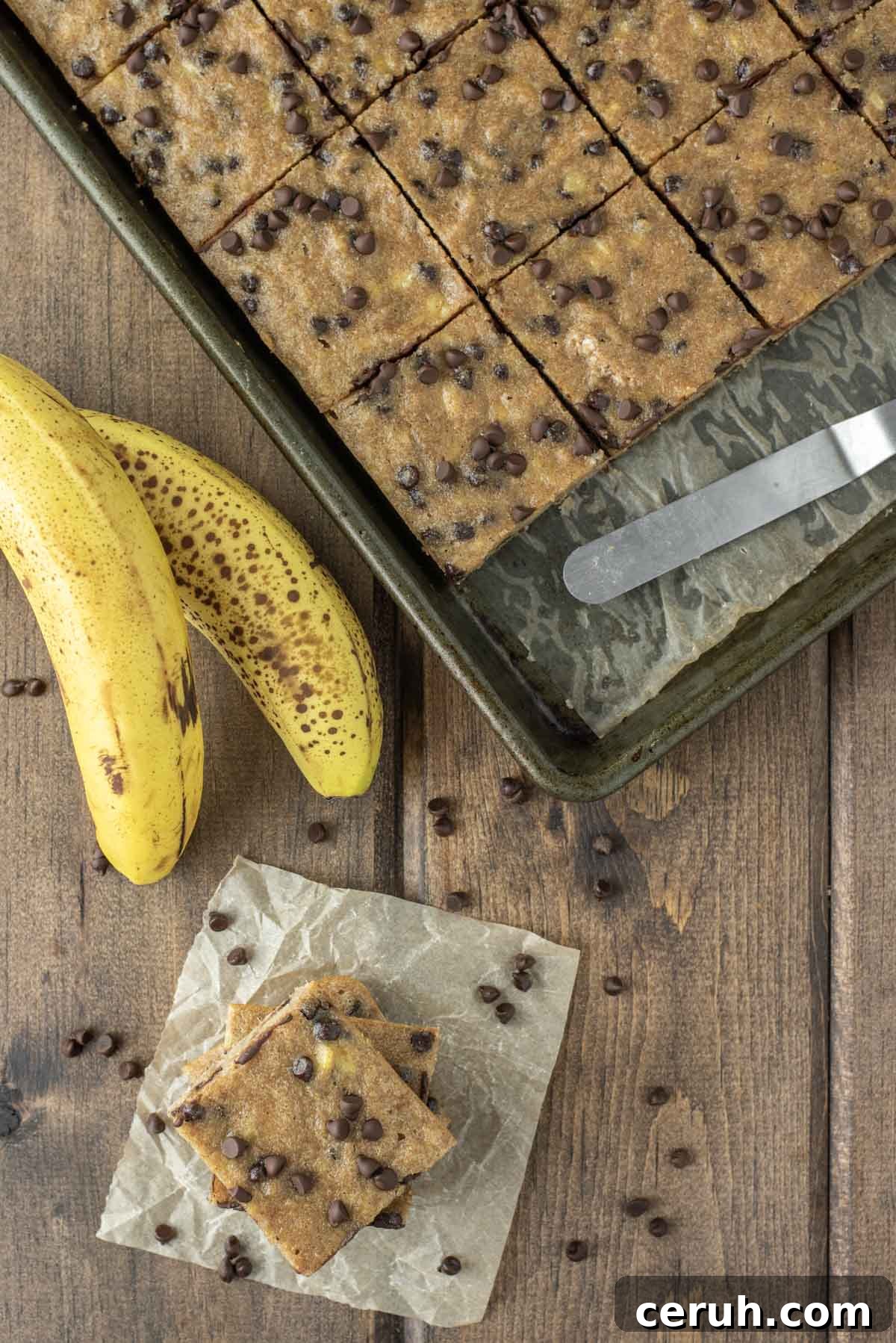 overhead shot of chocolate chip banana bars on parchment paper and in baking sheet