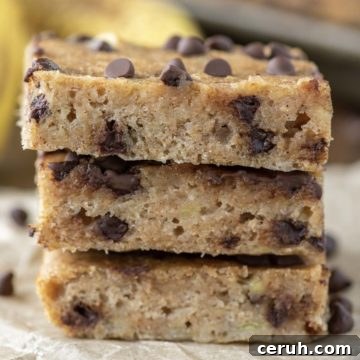 3 stacked chocolate chip banana bars on parchment paper