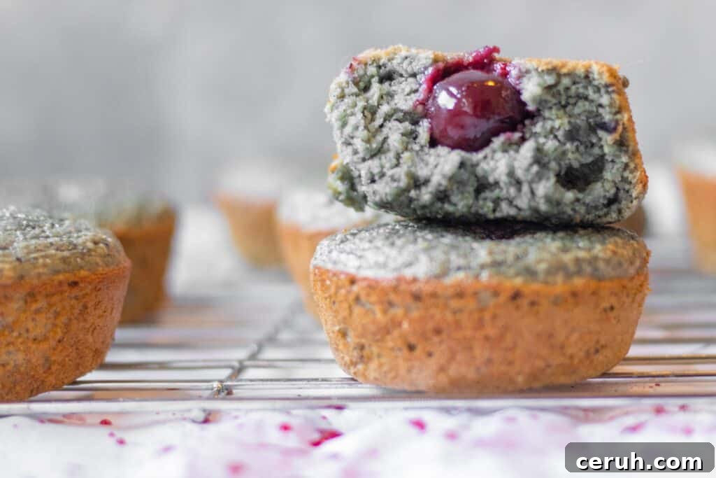 stacked cherry blender muffins with a cherry hidden in the middle