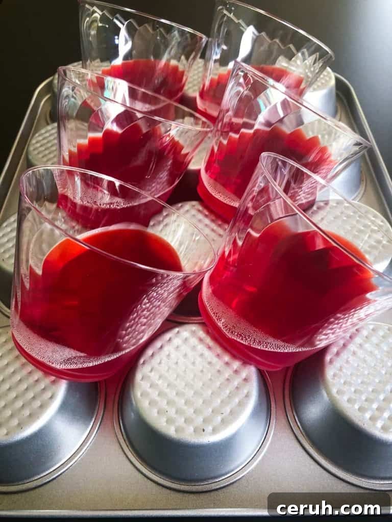 cups of red jell-o on muffin pan side view