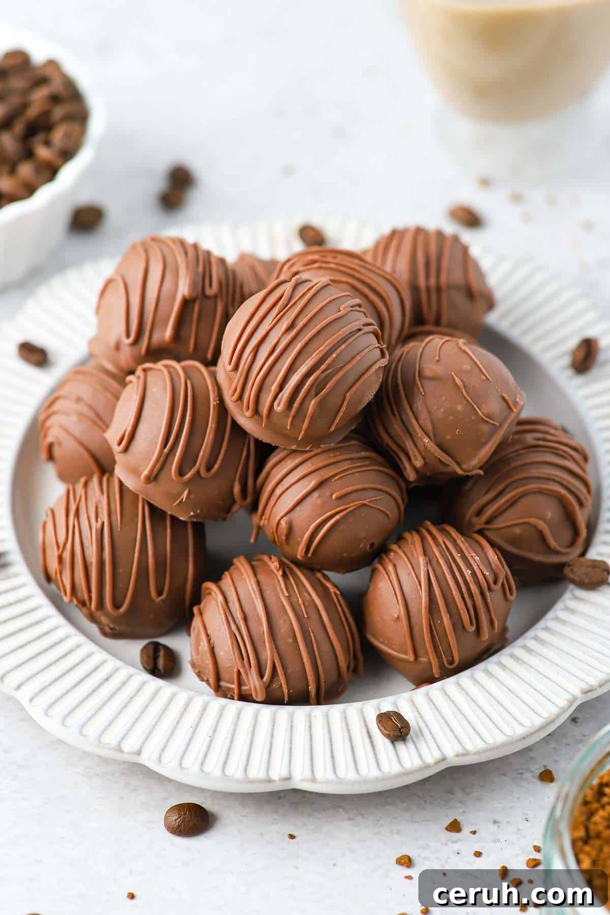 Plate of truffles sprinkled with some coffee beans.