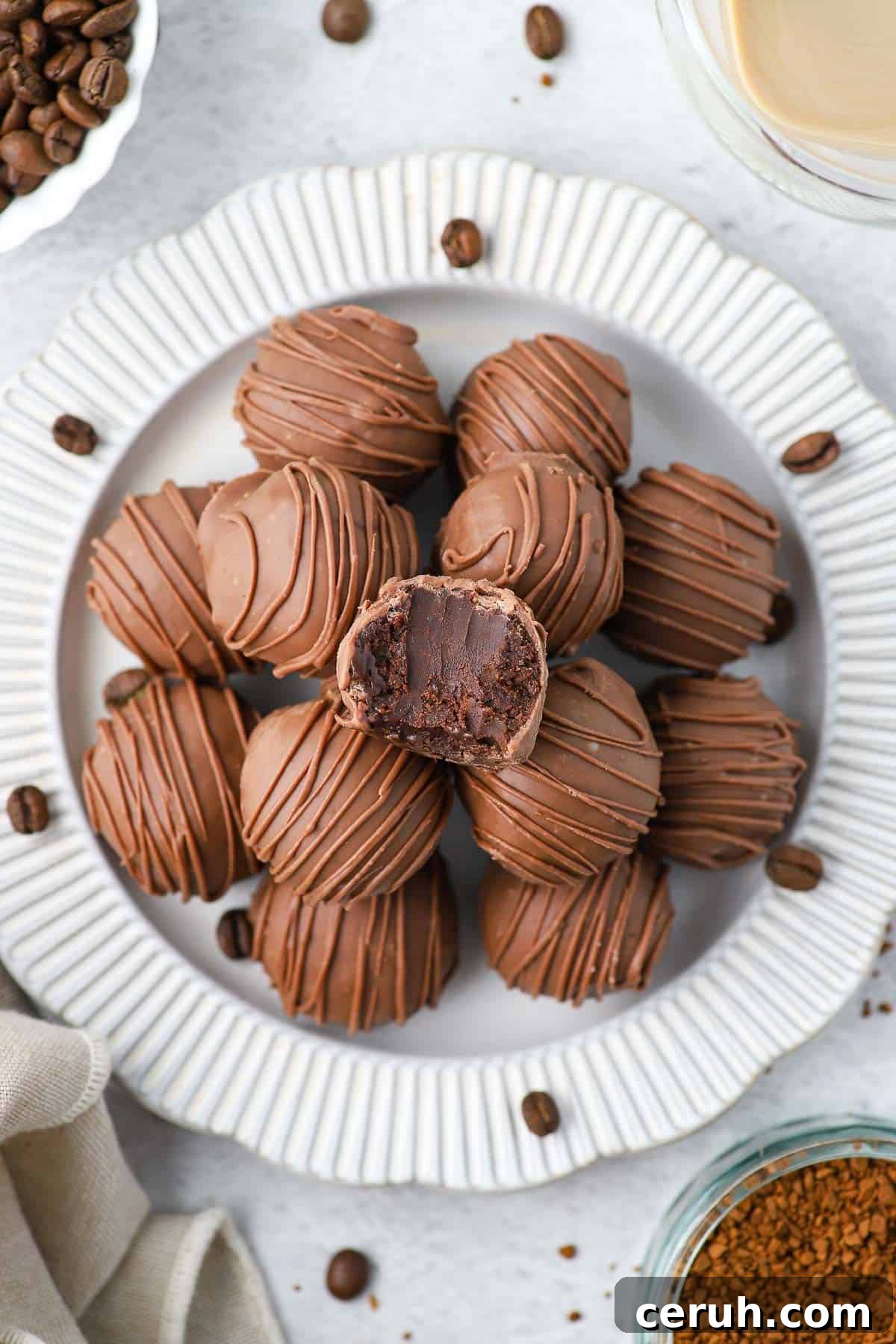Plate of truffles and one truffle missing a bite.