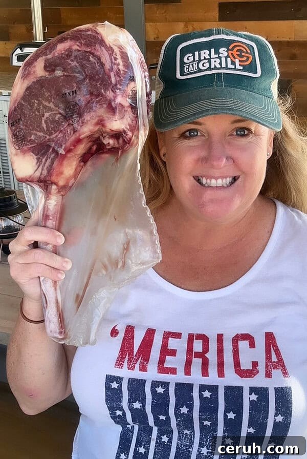 Christie Vanover holding a raw steak.