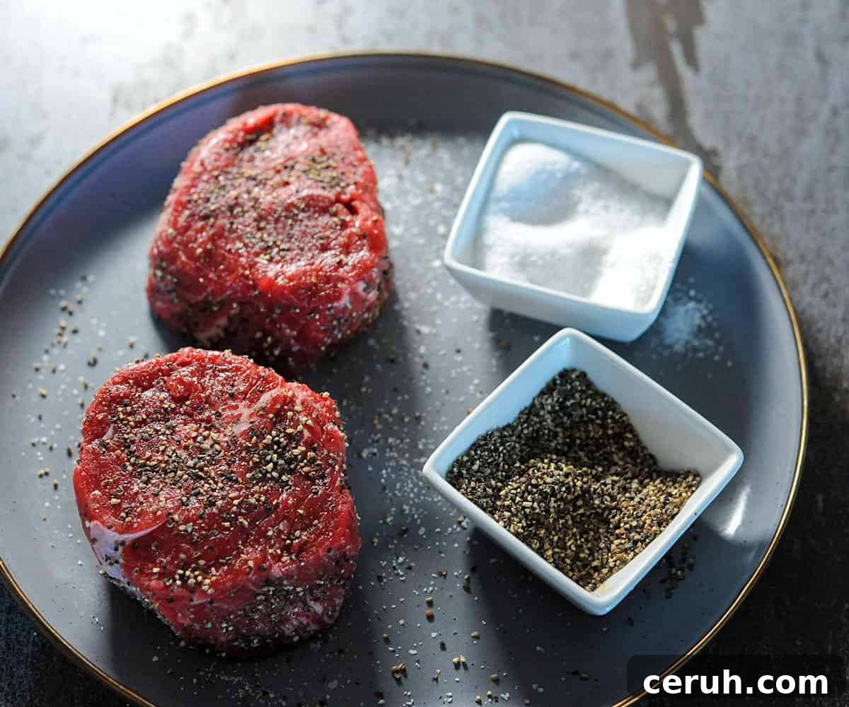 2 filet mignon steaks seasoned with salt and pepper.