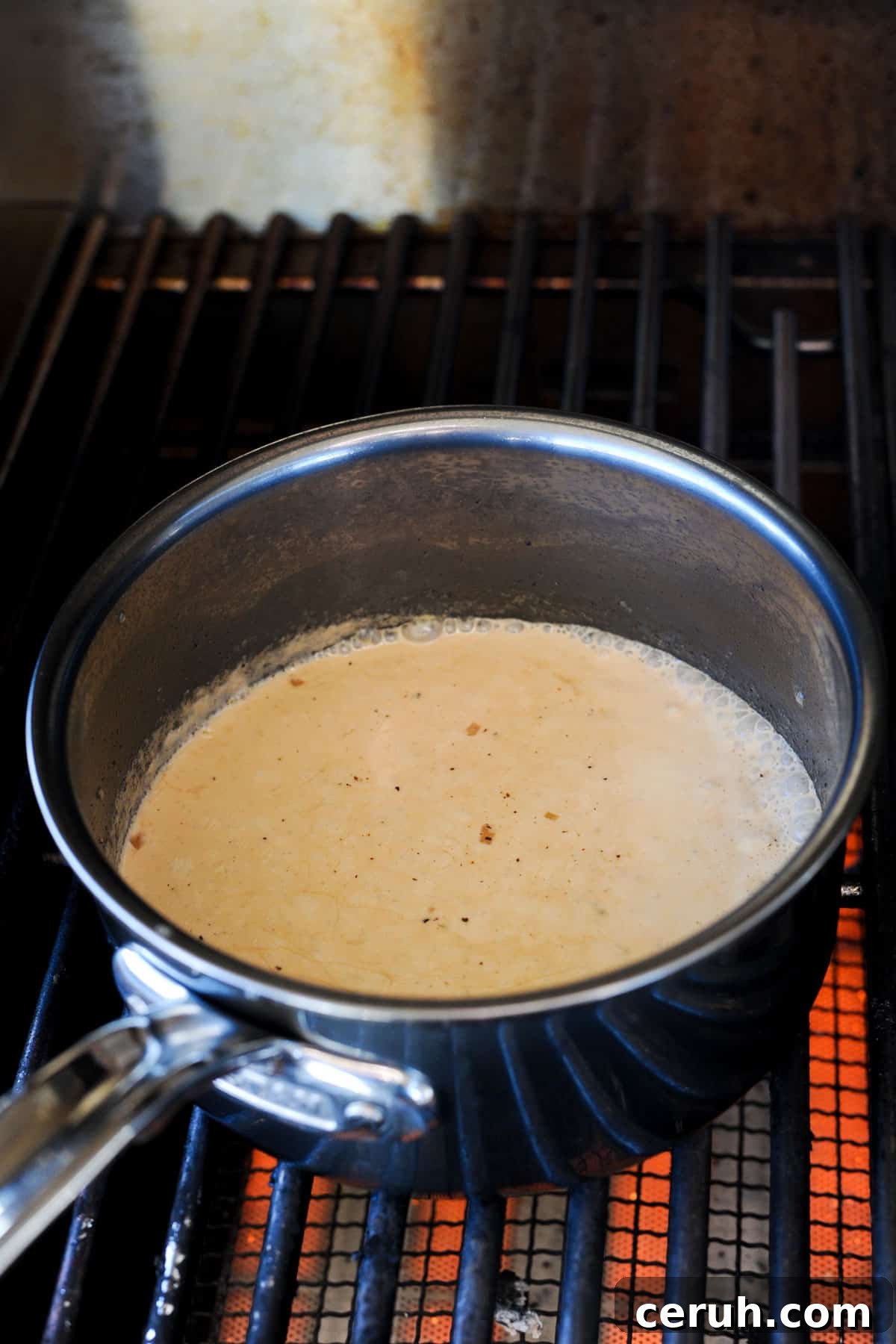 pot on grill with simmering cream.