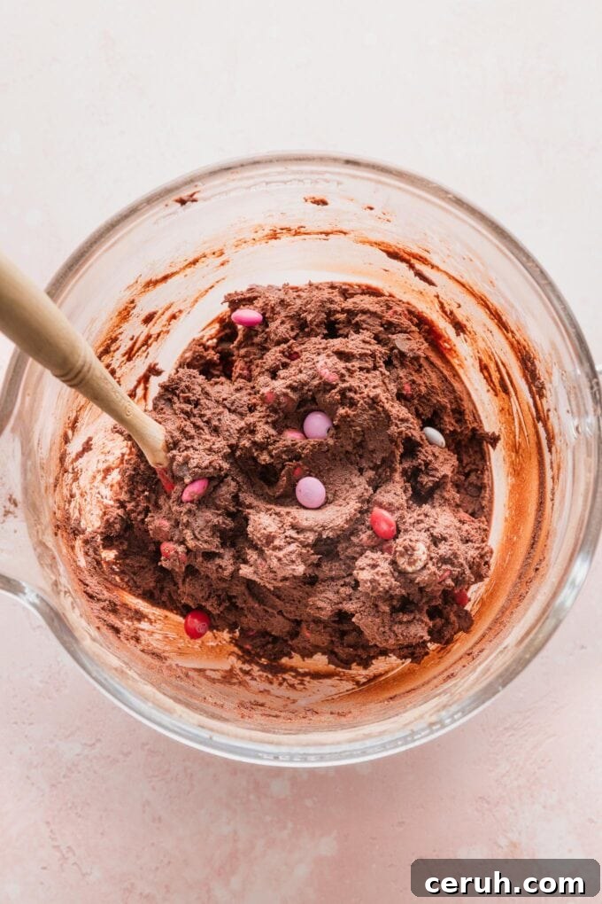 Close up of double chocolate cookie dough in a clear mixing bowl.