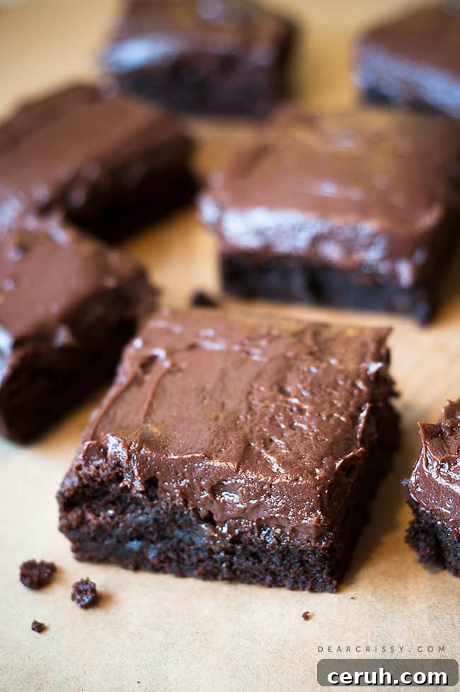 Best Chewy Brownies on Earth - You're going to love this rich and decadent frosted brownies recipe! Be sure to pin this now and try it later! - dearcrissy.com #brownies #chocolate