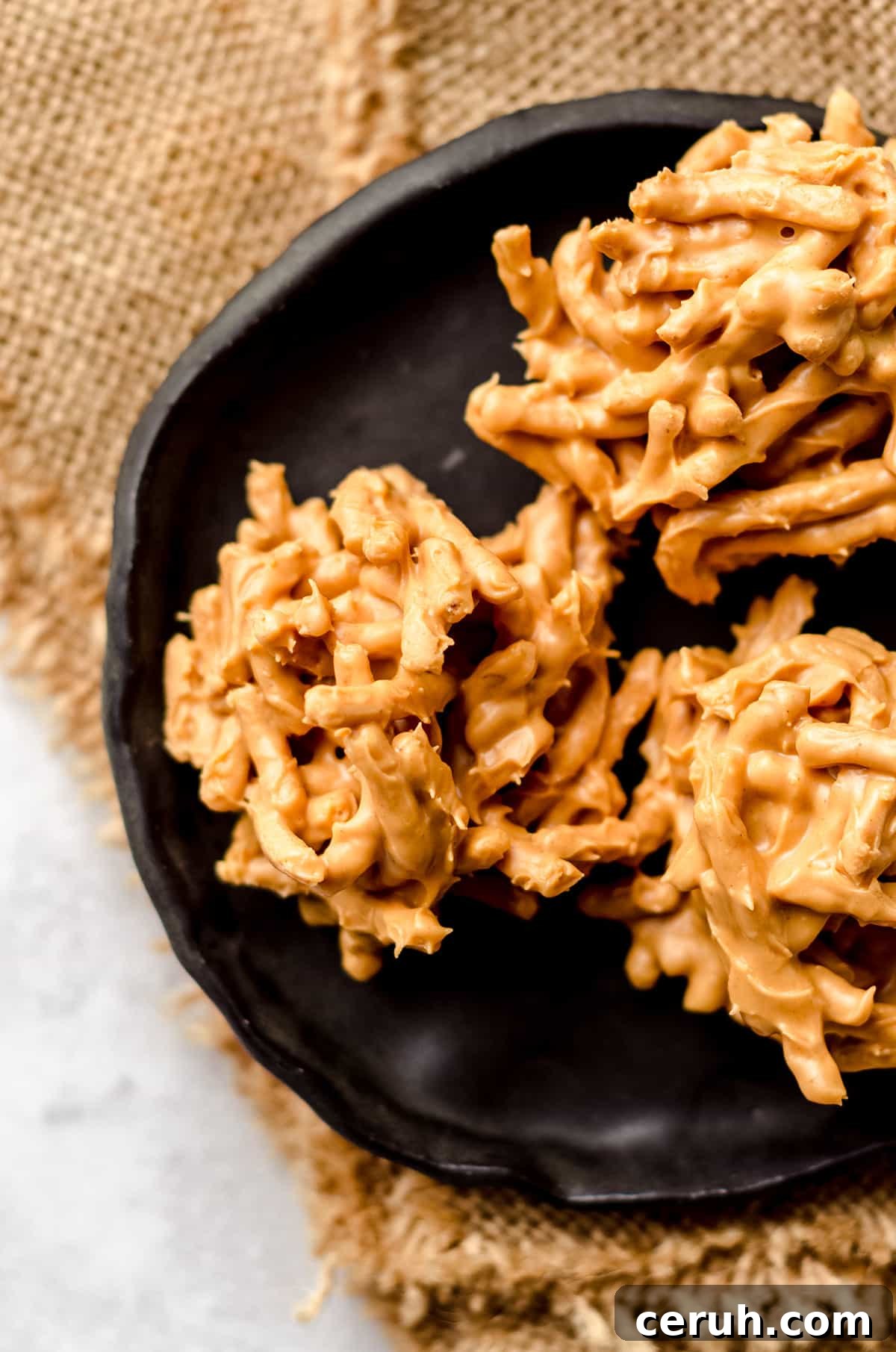 Chewy Butterscotch Haystack Cookies Recipe for Crowd-Pleasing Treats 3 A black plate with three haystack cookies.
