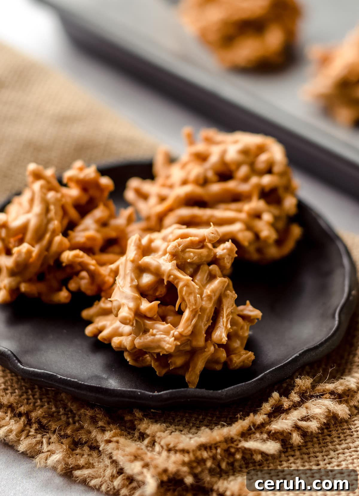 Chewy Butterscotch Haystack Cookies Recipe for Crowd-Pleasing Treats 4 A black plate with three haystack cookies on it.