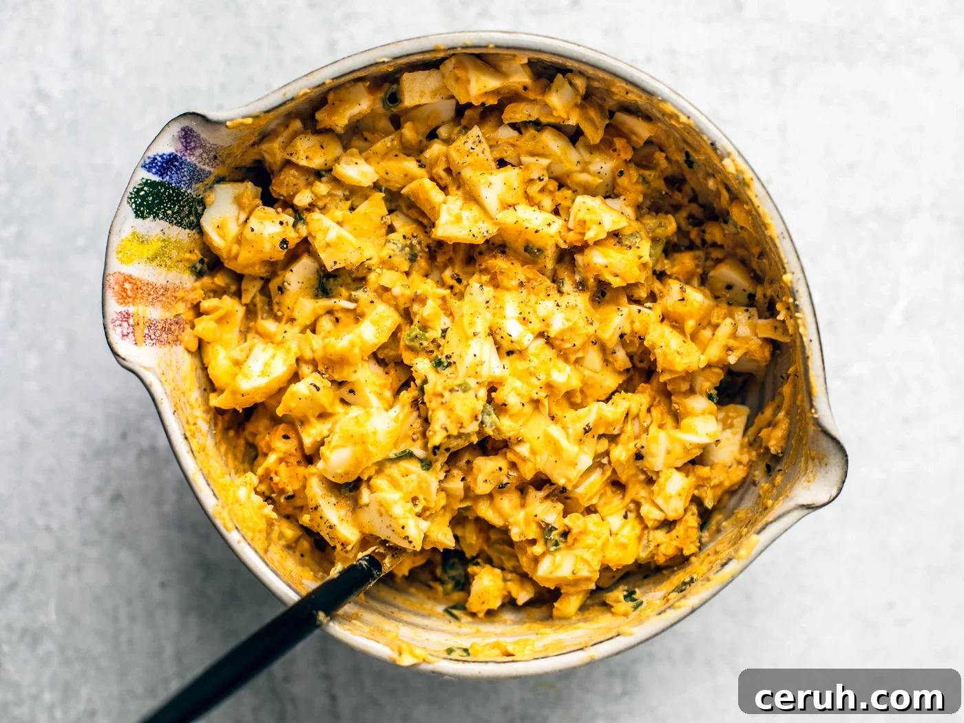 Mixing bowl full of completed egg salad.
