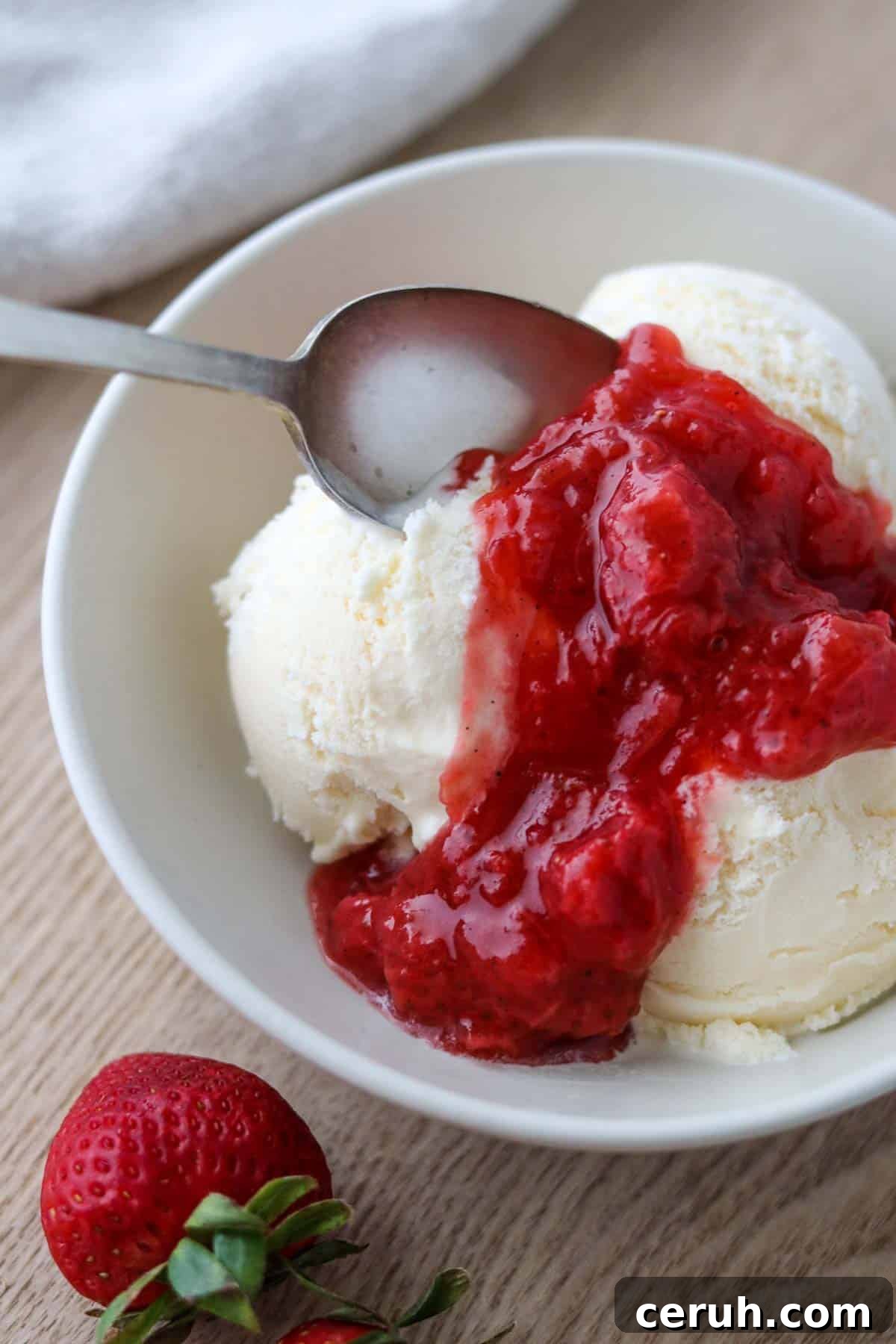 Strawberry Rhubarb Compote Recipe: Quick Homemade Fruit Sauce 8 Vanilla ice cream in a bowl topped with Strawberry Rhubarb Compote