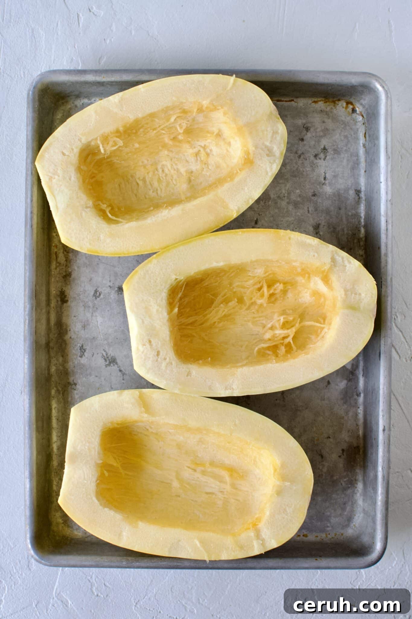 Spaghetti Squash, seeds removed, placed on a sheet pan.