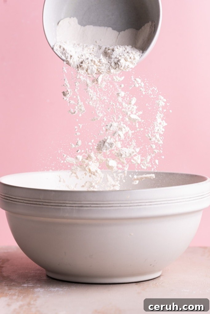Adding all-purpose flour to large mixing bowl.