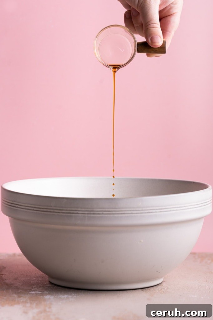 Adding vanilla extract to dry ingredients to make fluffy pancake batter.