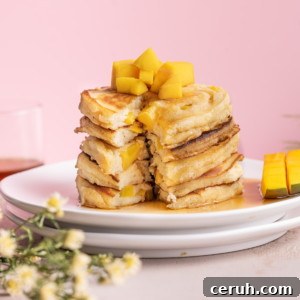 Stack of mango pancakes with slice taken out