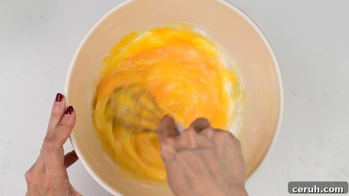 whisking eggs and sugar together in a bowl