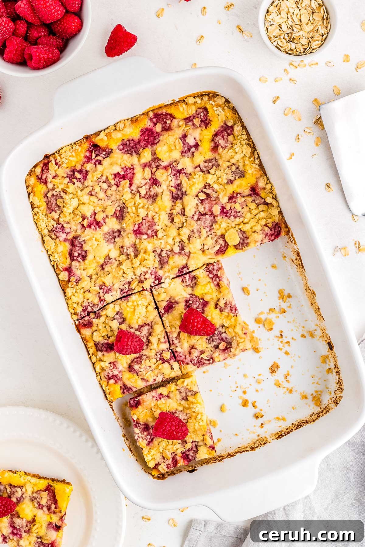 The finished raspberry oat bars in the baking pan and cut into squares.