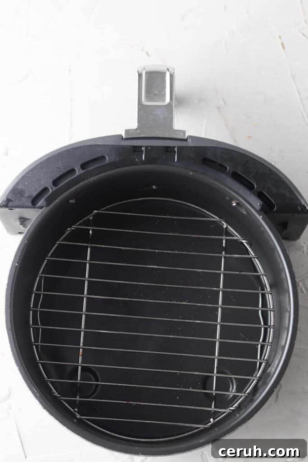 Empty air fryer basket without chicken tenders in it yet. 
