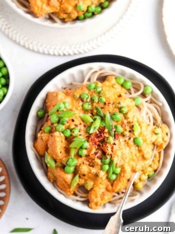 cajun chicken over pasta in a bowl