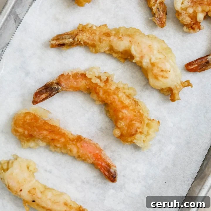 crunchy crispy golden ebb shrimp tempura on sheet pan.