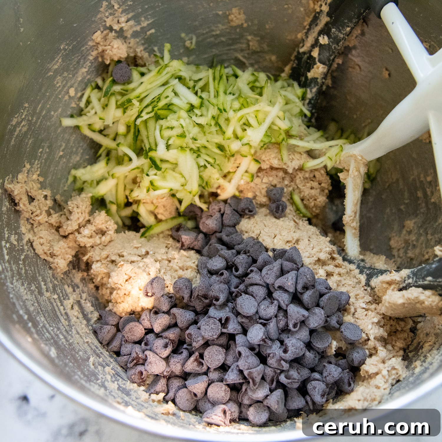 Soft Chewy Gluten-Free Zucchini Cookies That Stay Moist 5 chocolate chips and the zucchini in a mixing bowl with the cookie dough.