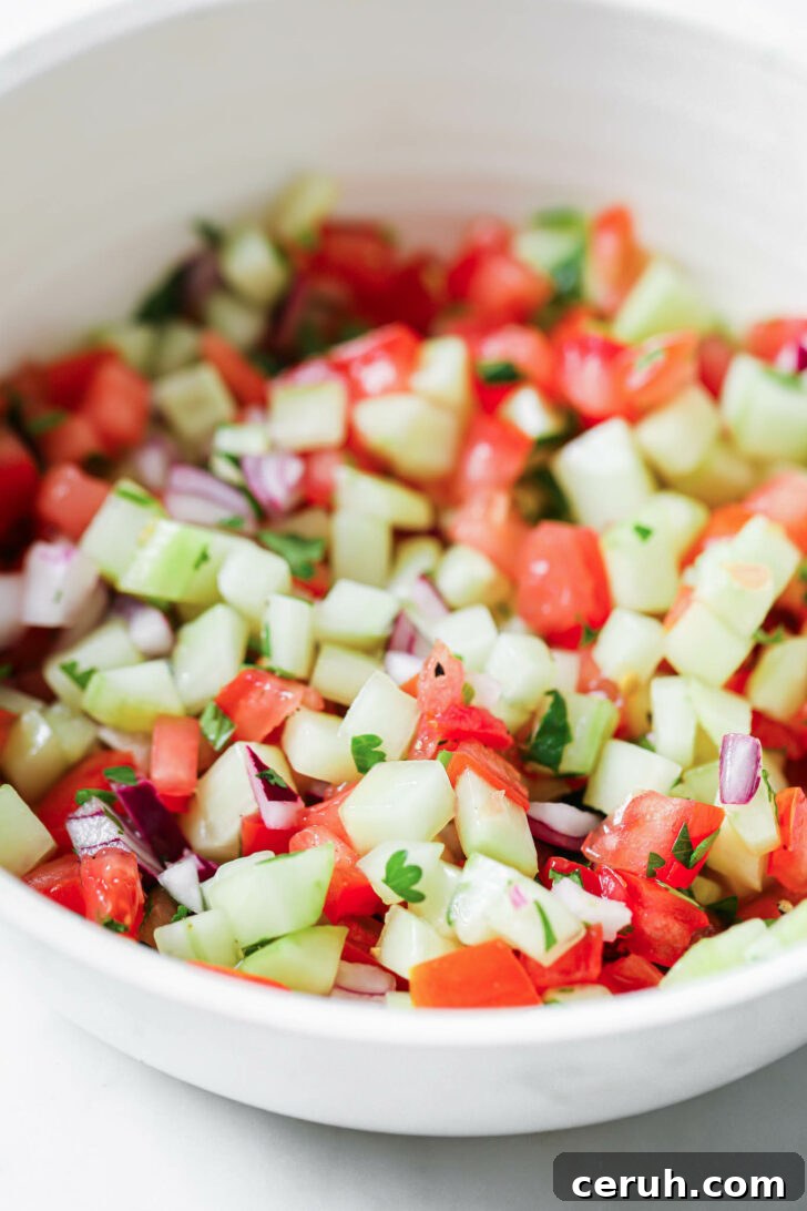 Kachumber salad in a white bowl.