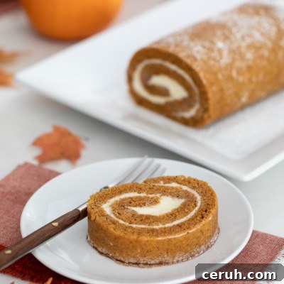 pumpkin roll on platter with a slice served on a plate.