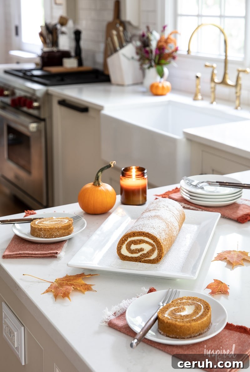 pumpkin roll served on plates with cloth napkins on a kitchen counter.