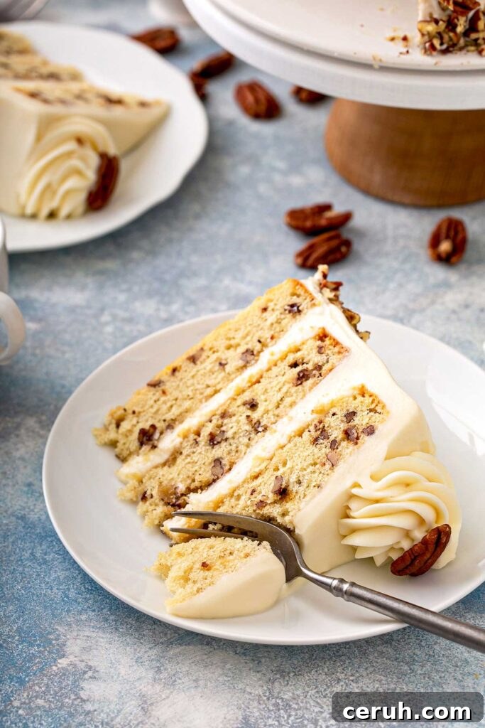 Sliced of layered butter pecan cake on a white plate