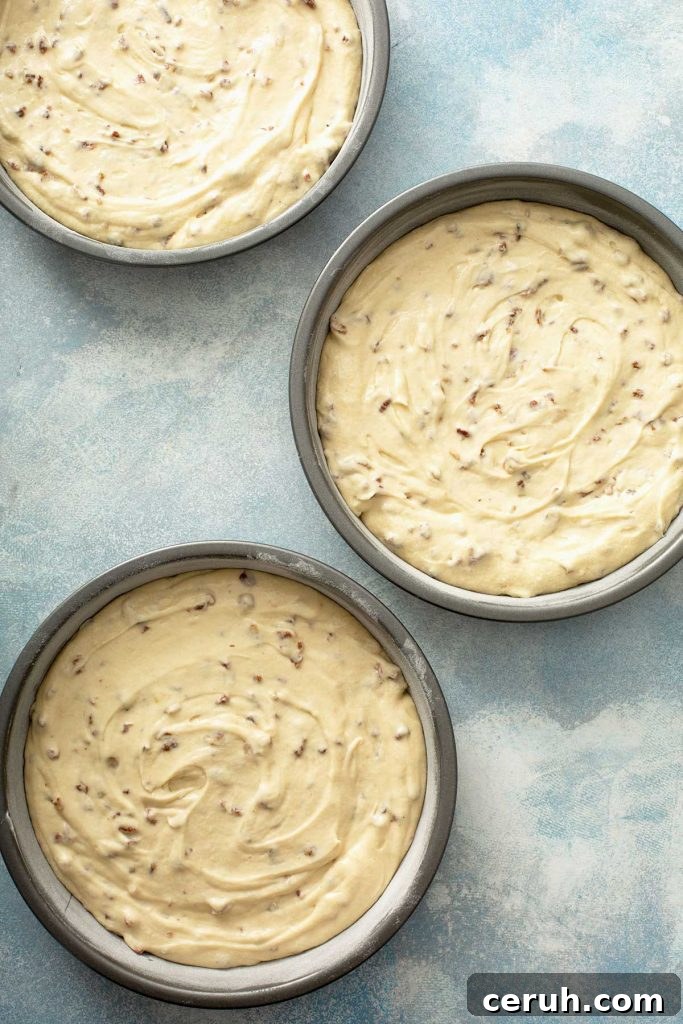butter pecan cake batter divided in 3 baking pans