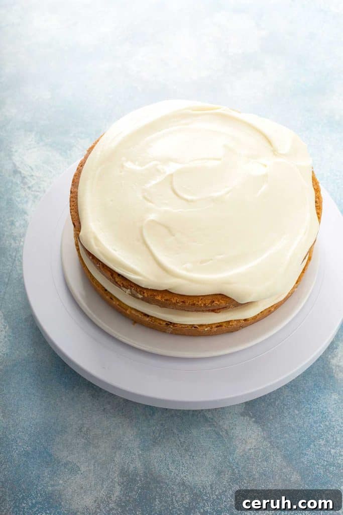 assembling the butter pecan cake with the cream cheese frosting
