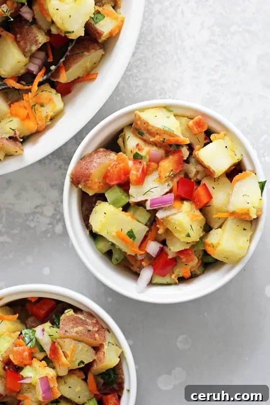 Three white dishes filled with Vegan Potato Salad.