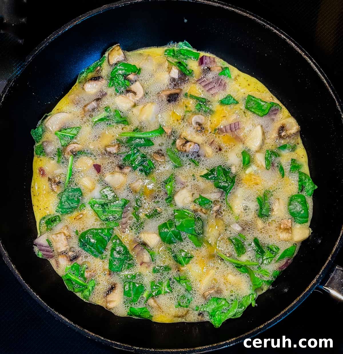 The omelette ingredients poured into a skillet.