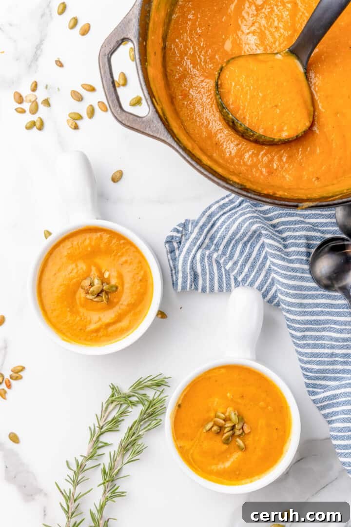 butternut squash soup in pot and served in white bowls.