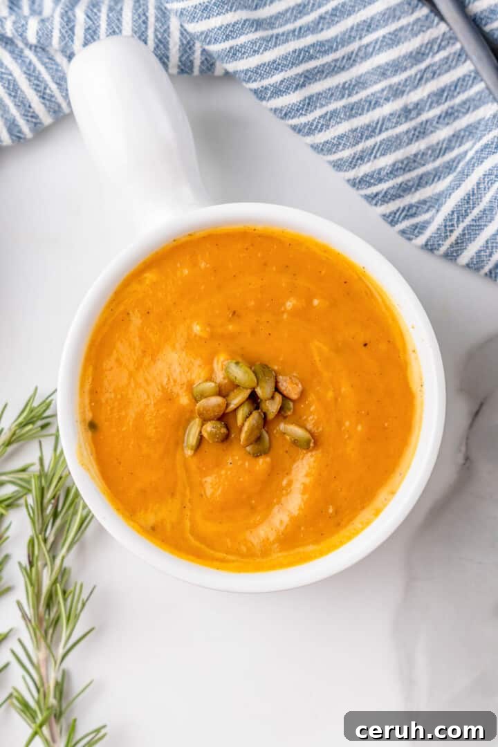 closeup of the butternut squash soup in white bowl.