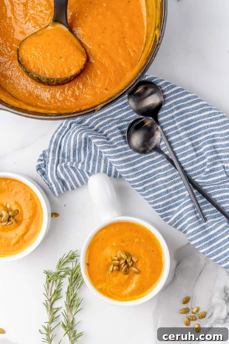 butternut squash soup served in two white bowls.