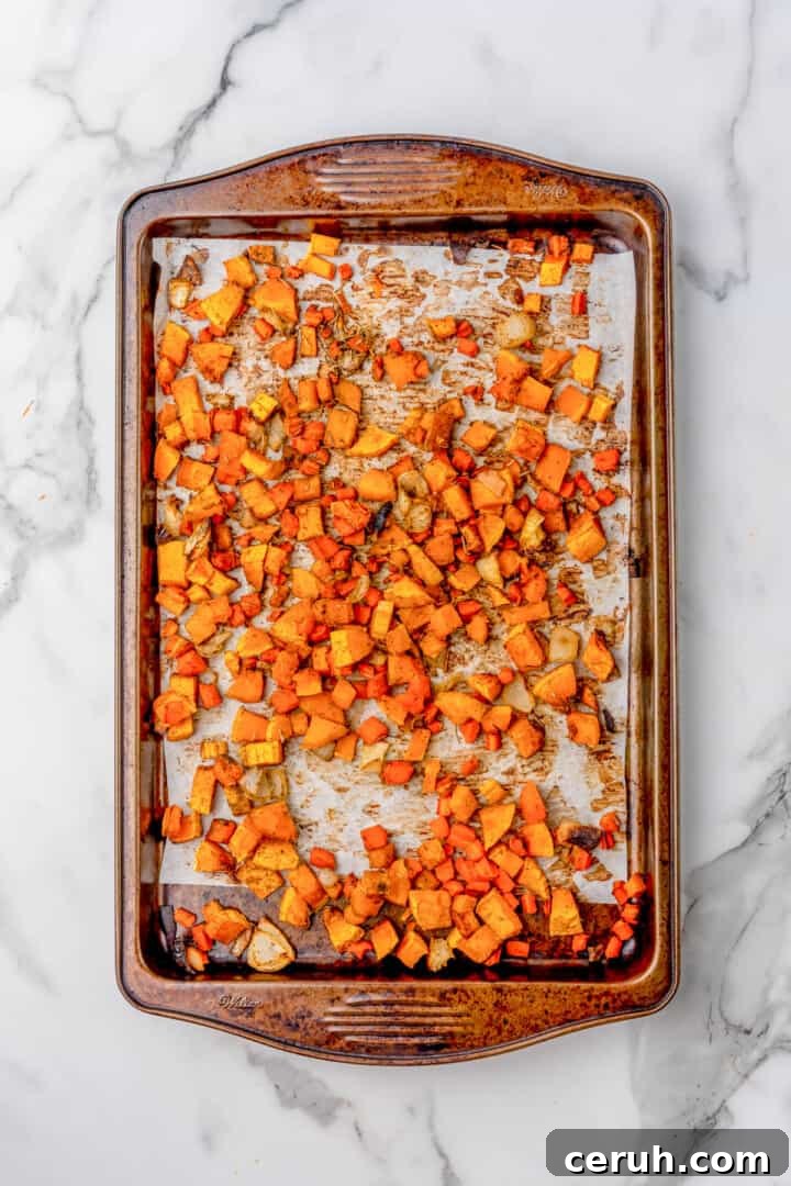 roasting the butternut squash and carrots on a baking sheet.
